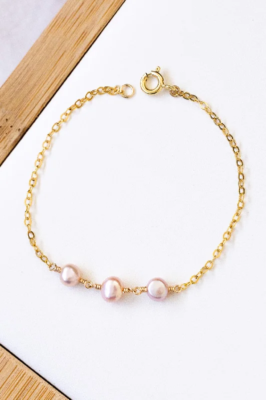 Ladies bracelets worldwide appeal-Triple Flat Pink Pearl Bracelet